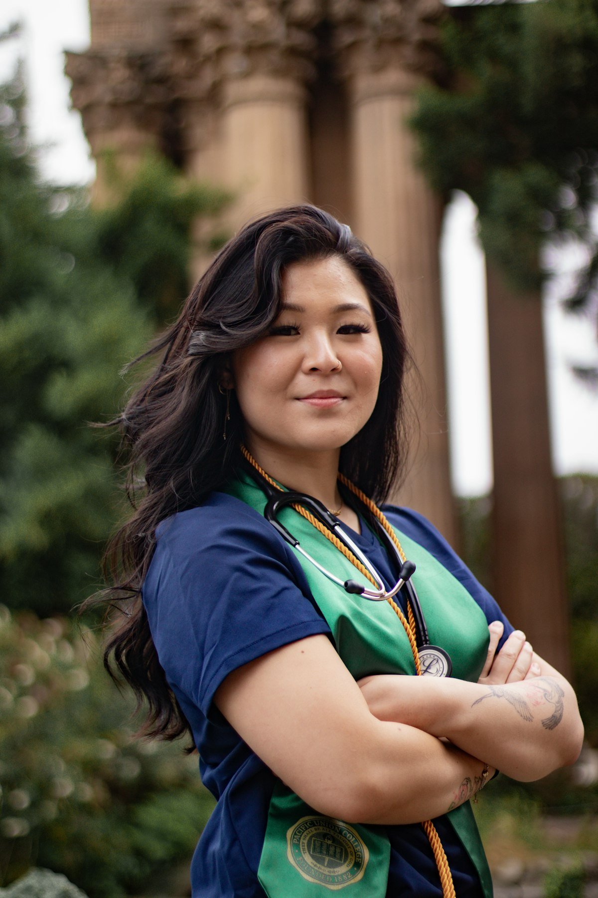 A nurse in scrubs wearing a stethoscope